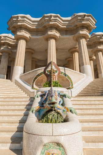 The iconic multicolored trecandis mosaic dragon at the steps of the Sala Hipostila iconic terrace in Gaudi's Parc Guell, Barcelona, Spain. ProPhoto RGB profile for maximum color fidelity and gamut.