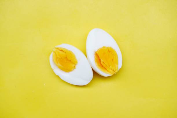 istock boiled egg isolated on yellow background. Hard boiled egg on isolated background. Breakfast concept 1699689968