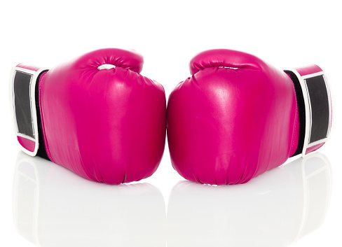 A pair of pink boxing gloves on an isolated white background.