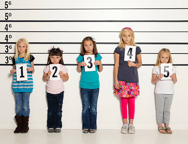 Police Line-Up of Five Little Girls A police station line-up of five unhappy little girls. child arrest stock pictures, royalty-free photos & images