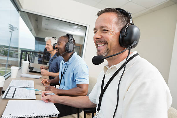 istock Sports commentators wearing headsets; reporting from stadium press box 169969699
