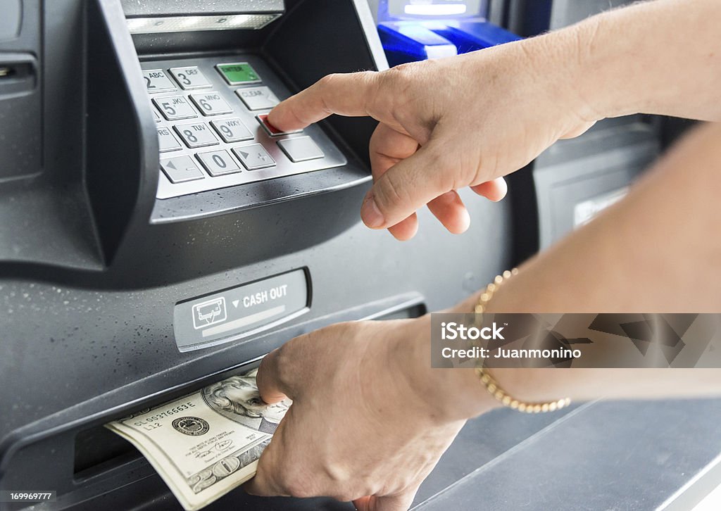 Getting the cash caucasian female hand picking the cash from an ATM Cashier Stock Photo