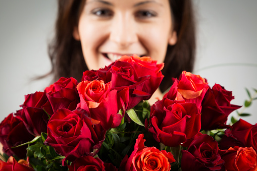 woman holding bouquet of roses