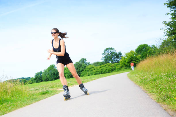 young woman with inline skates, skating in a park