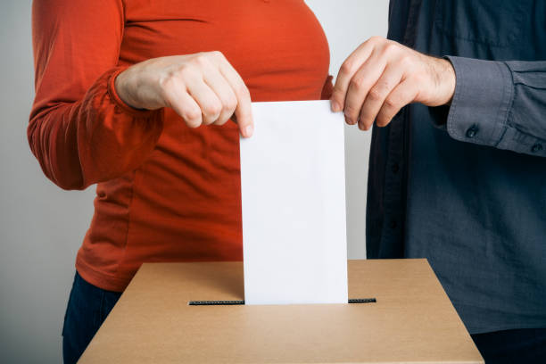 istock man and woman casting their vote 169971655