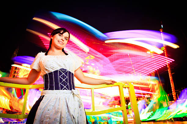 istock young woman standing next to brightly colored carousel 169971702