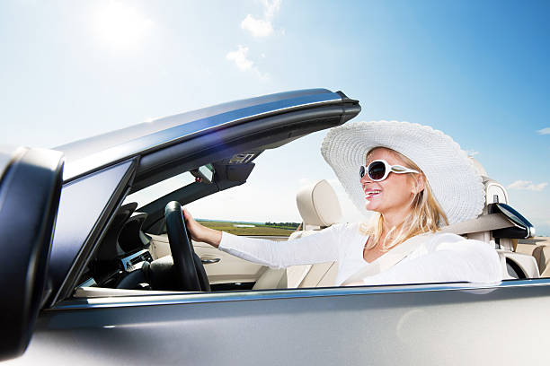 istock Happy woman driving a cabriolet car. 169971864