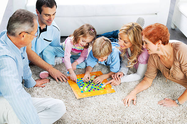 istock Cheerful extended family playing board game on the floor. 169971989