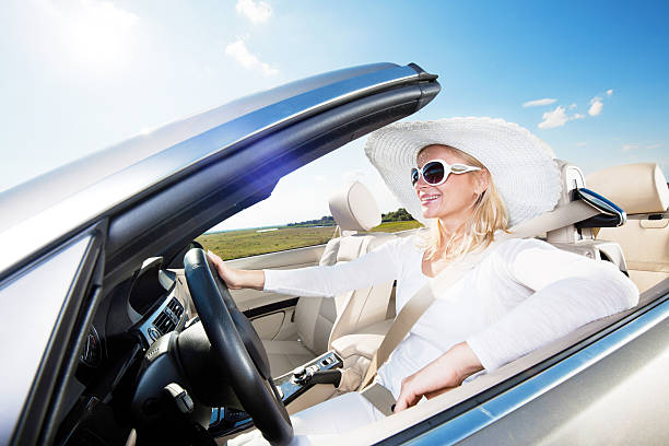 istock Happy woman driving a cabriolet car. 169972012