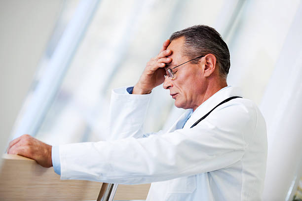 istock Mature adult doctor having a headache. 169972055