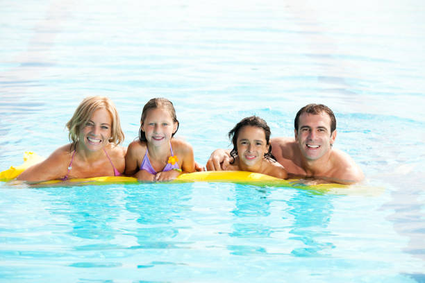 istock Smiling family enjoying in the pool 169972265