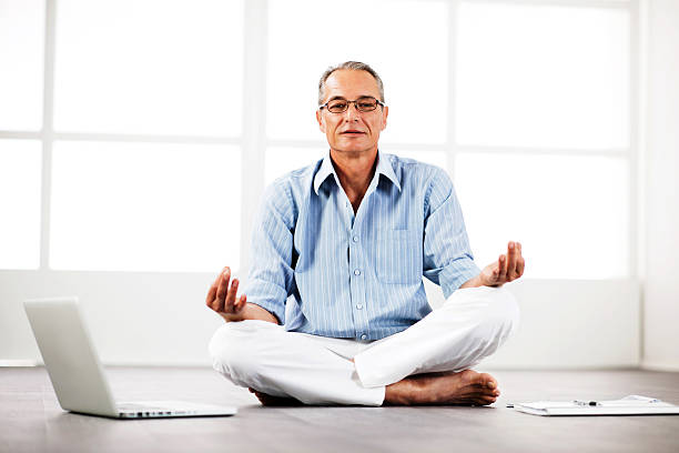 istock Senior businessman meditating at home 169972341