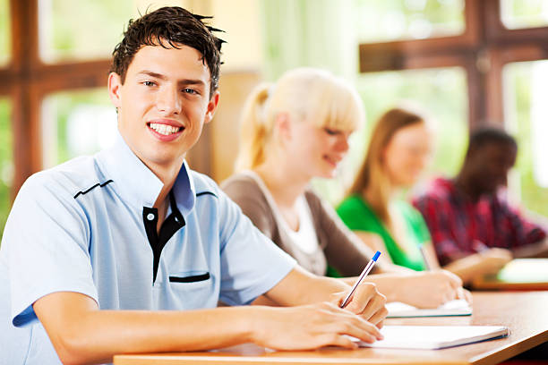 istock Group of teenage students writing in their notebooks. 169972435