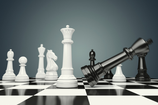 Black chess pieces on the board for business strategy planning concept. Focus on black queen