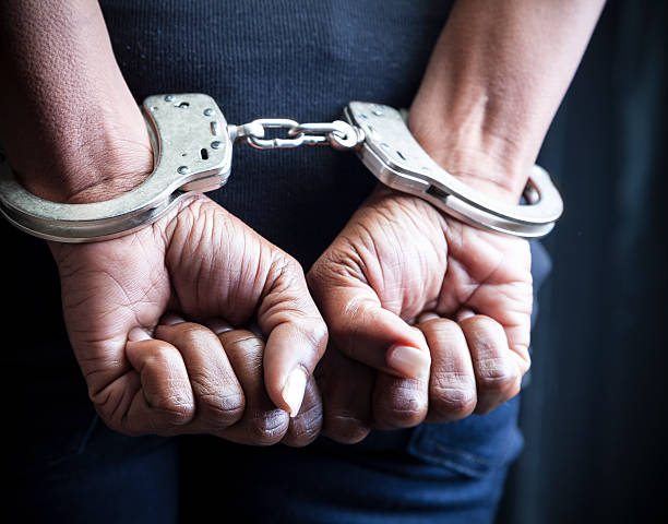Arrested Black woman in handcuffs criminal stock pictures, royalty-free photos & images