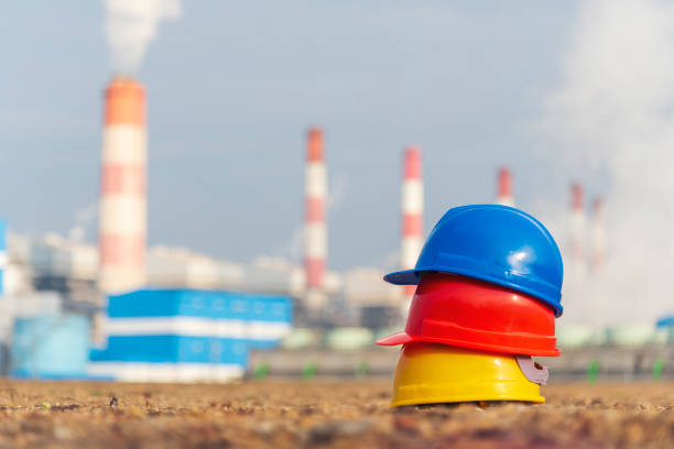 istock Worker Hard hat at Power stations manufacturing electrical industrial plant. Construction hard hat safety helmet Electric power building refinery engineering safety tools Lignite electricity chimneys 1699733198