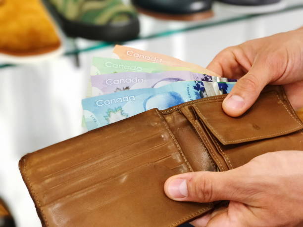 istock Man's hand holding wallet with dollars 1699735019