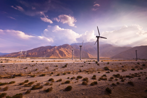 Rows of wind turbines at the Palm Springs Wind Farm slowly rotate in the empty desert