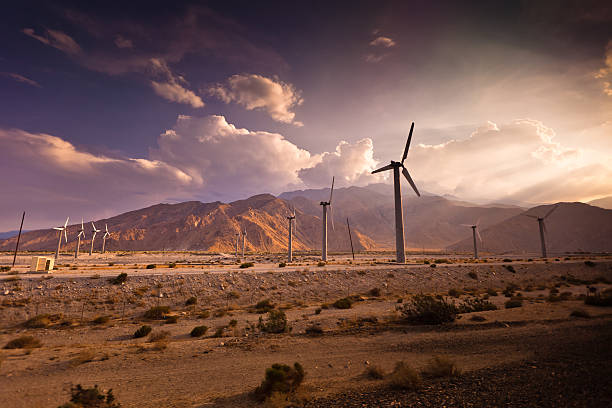Rows of wind turbines at the Palm Springs Wind Farm slowly rotate in the empty desert