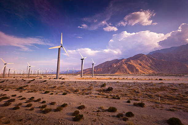 Rows of wind turbines at the Palm Springs Wind Farm slowly rotate in the empty desert