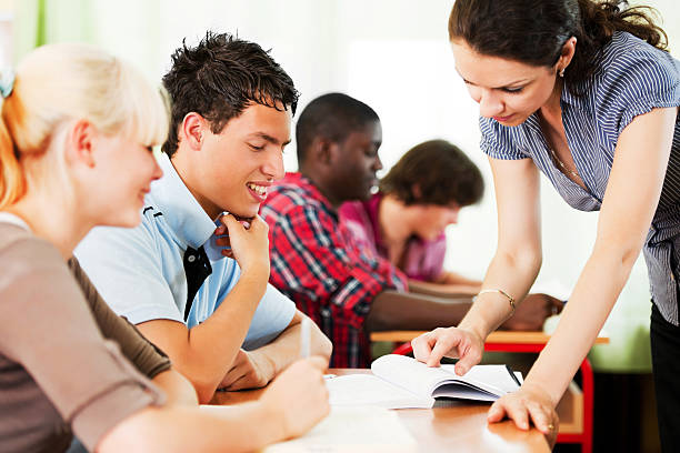 istock Teenage students in the classroom with teacher. 169974145
