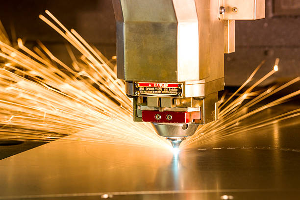 Metal, laser-cutting tool. A photograph of a metal, laser-cutting machine. laser cutting metal stock pictures, royalty-free photos & images