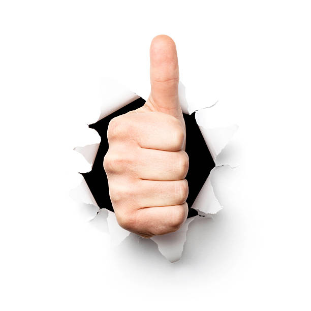 istock Thumbs up. Hand Tearing Hole Torn Paper Isolated Concept 169974938