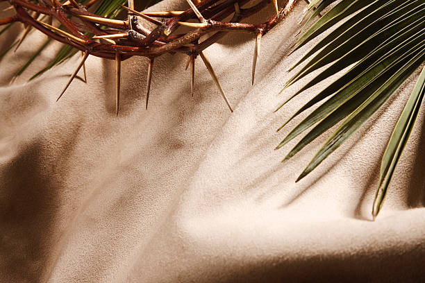 Crown of thorns and palm branch with space for text.
