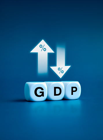 GDP business concept. Word GDP Gross domestic product on white cube block near up and down arrows with percentage icon. Business growth and measure for the size of economy compiled for a country.