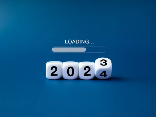 istock Loading to Merry christmas and begin a happy new year 2024 banner background. Loading, text appears on white flipping blocks with 2023 change to 2024 year numbers on blue background, minimal style. 1699766005