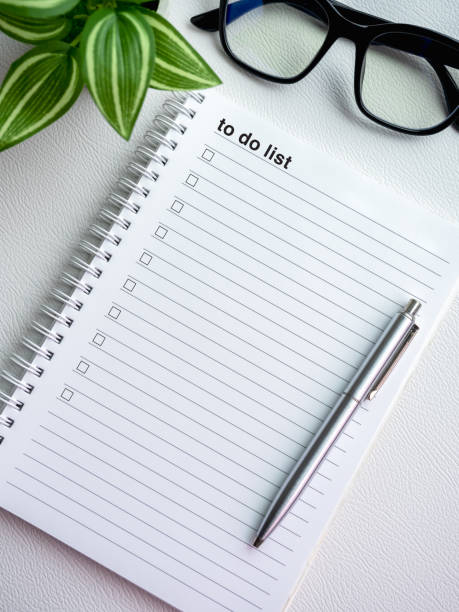 istock To do list. Text and checklist with empty checkboxes on blank notepad page with pen, glasses and green leaves in pot on white background, vertical style. Business goals plan, resolutions concepts. 1699766006