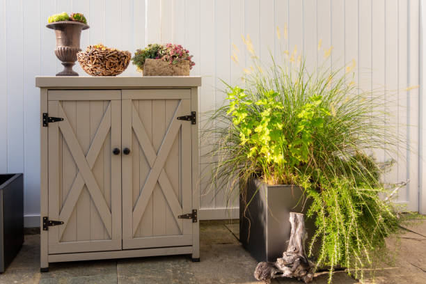 istock A little cabinet with different decorations and a flower pot with green plants on a terrace 1699766092