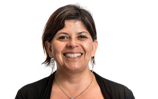 Picture of a smiling hispanic female model at her forties on white background 