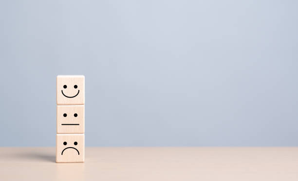 istock Customer service rating experience and feedback emotion and satisfaction survey concept. Wooden cube with smiley, normal and sad face icon. Positive, Client show Neutral or Negative facial expressions. 1699774797