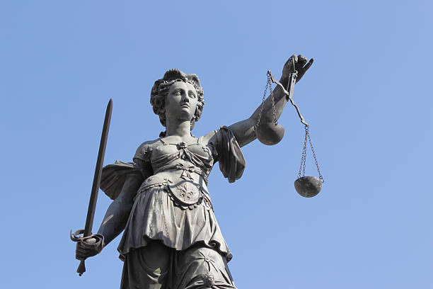 istock sword and blue sky with ancient lady Justice Justitia 169977657