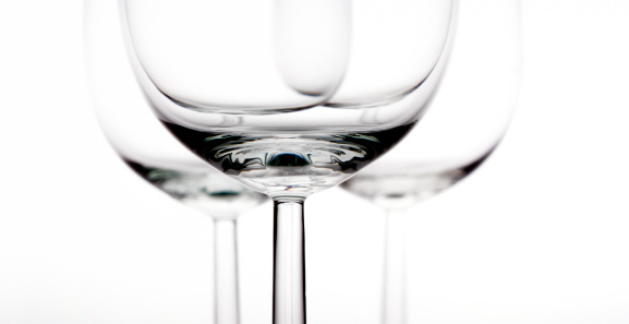 close up on empty wineglasses, focus on the foreground on white background