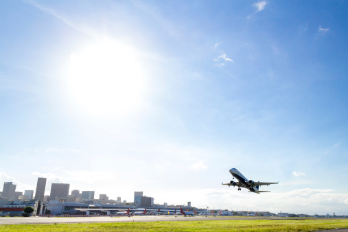 Airplane takeoff at Rio de Janeiro airport Santos Dumont on a clear sunny day.