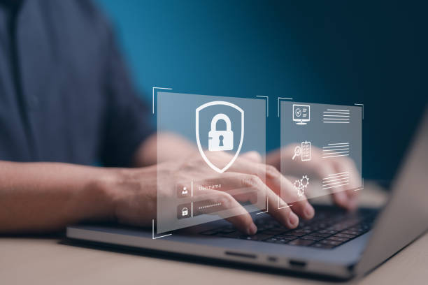 istock Login on a notebook. Businessmen protecting personal data on laptop and virtual interfaces. User authentication system with username and password, Information, Encryption or Cyber security concept. 1699781456
