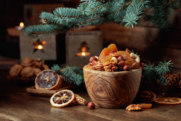 istock Dried fruits and assorted nuts on an old wooden table. 1699785142