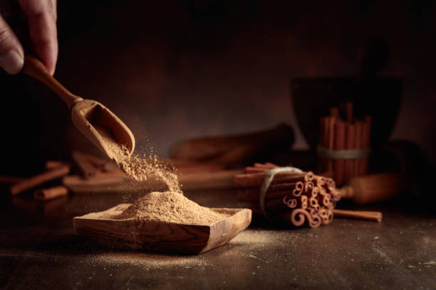 istock Cinnamon powder is poured into a wooden bowl. 1699785165