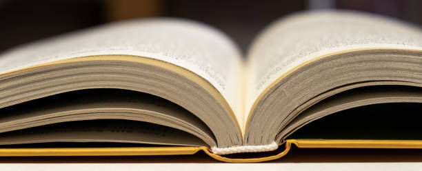 istock Open book close up. One book is yellow. 1699809608