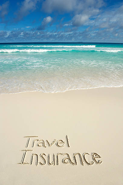 istock Travel Insurance Message Written on Bright Tropical Beach 169980986