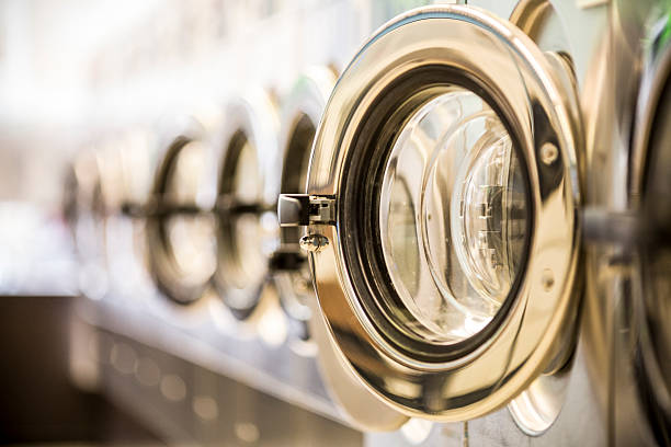 Washing machines - clothes washer’s door in a public launderette Washing machines laundry stock pictures, royalty-free photos & images