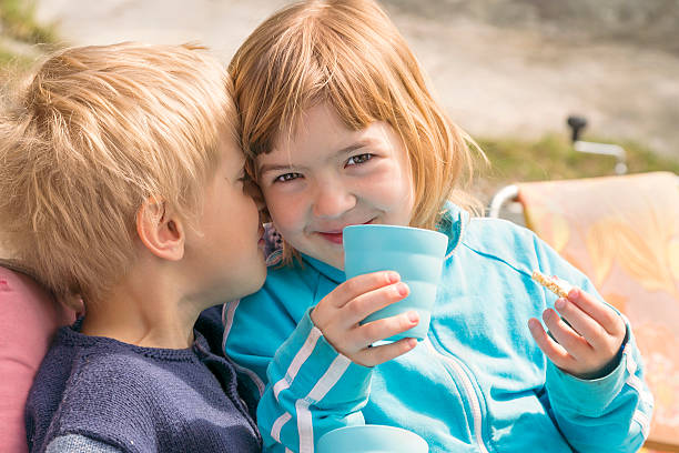 istock Two young friends sharing a whispered secret. 169983136