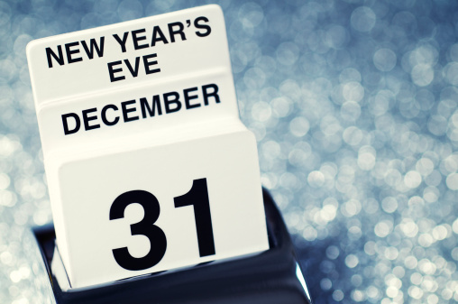 Calendar showing New Years Eve December 31 with a festive sparkling silver background