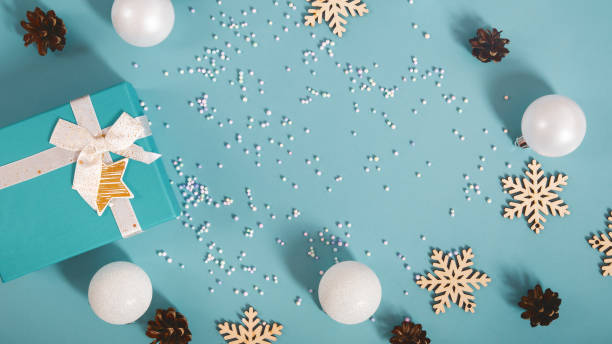 istock Christmas composition with gift boxes, decorations, snowflakes on a light blue background. Top view. Copy space 1699835333