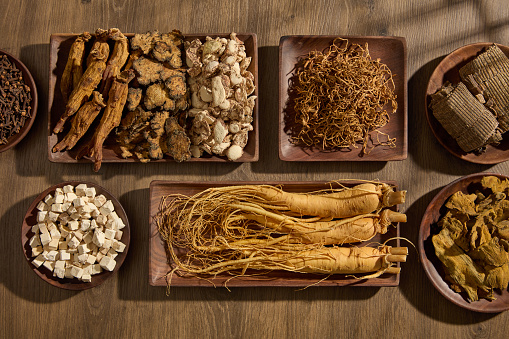 Variety of herbs are displayed on wooden trays in different shapes. For medicine advertising, photography traditional medicine content