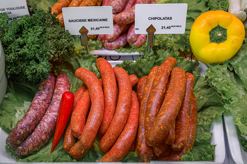 Artisanal Mexican and chipolata pork sausages on display at a butcher shop on on the Grande Ile in the historic center of Strasbourg, Alsace France