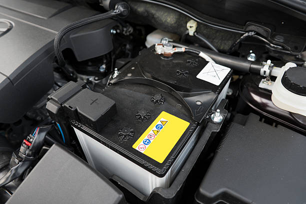 Car Battery Car battery under the hood. car battery stock pictures, royalty-free photos & images