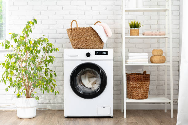 istock Laundry basket on washing machine in a laundry room 1699860759